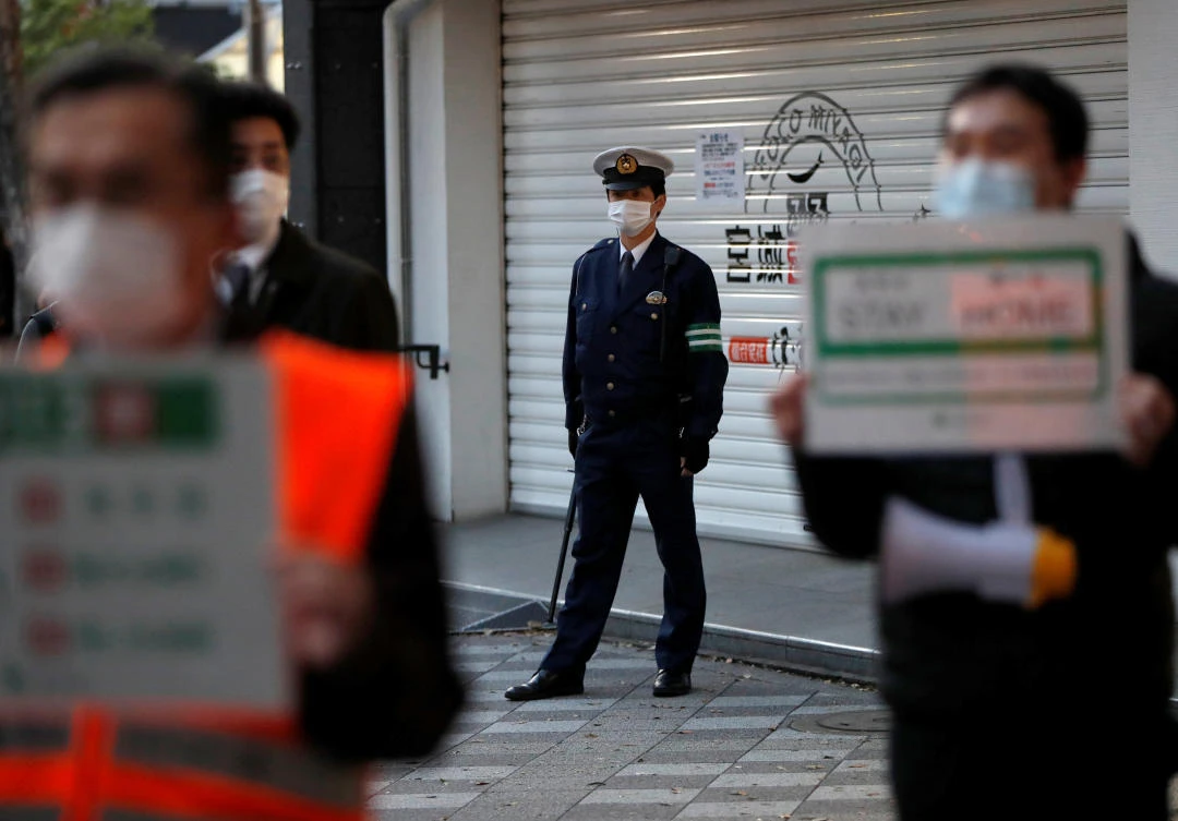 Japan has seen an accelerating infection rate in recent weeks, particularly in Tokyo. Above, officials of Tokyo’s metropolitan government call for people to stay home on April 14, 2020. (Reuters)
