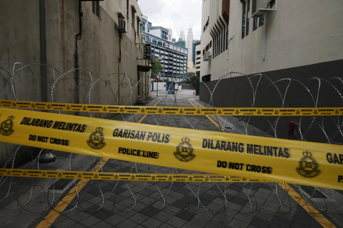 Above, barbed wire and police line cordon at an entrance of the red zone under enhanced lockdown in Kuala Lumpur on April 15, 2020. Malaysia has a total number of coronavirus infections to 5,072. (Reuters)