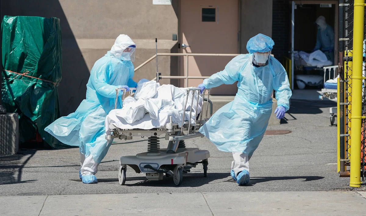 Bodies are moved to a refrigeration truck serving as a temporary morgue at Wyckoff Hospital in the Borough of Brooklyn on April 6, 2020 in New York. (AFP)