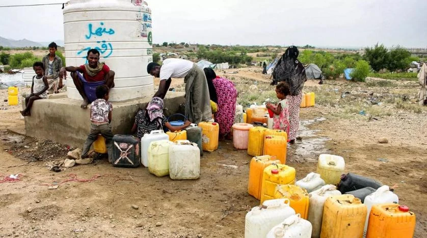 People load up on water from a cistern at a makeshift camp for displaced Yemenis in the Hajjah province. (AFP)