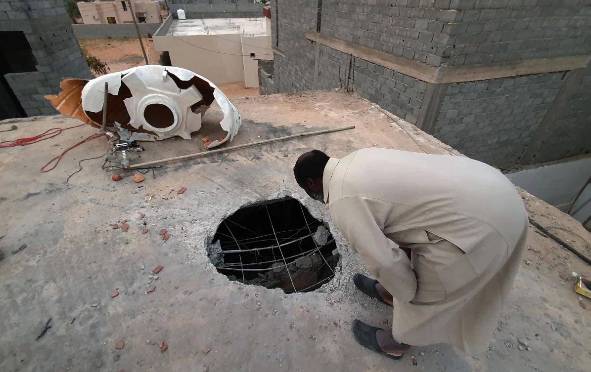 A Libyan checks the site of shelling on the residential area of Arada in the capital Tripoli on April 14, 2020. (AFP)