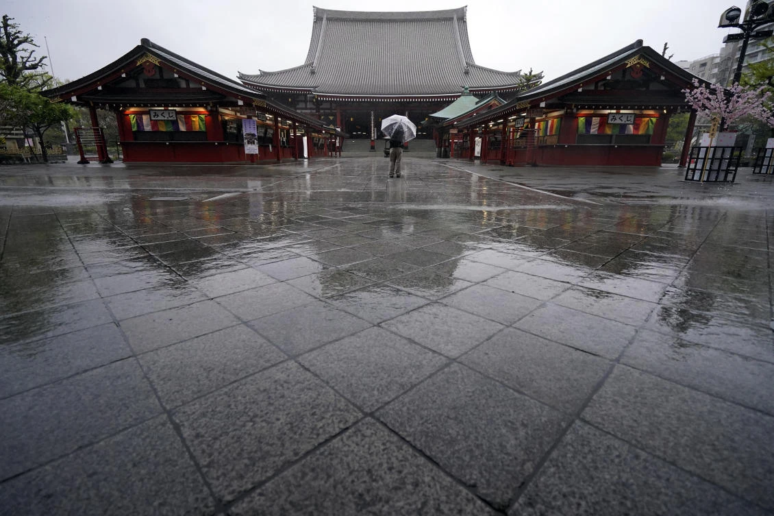 A man stands at Sensoji Temple in the empty Asakusa district Monday, April 13, 2020, in Tokyo. (AP)