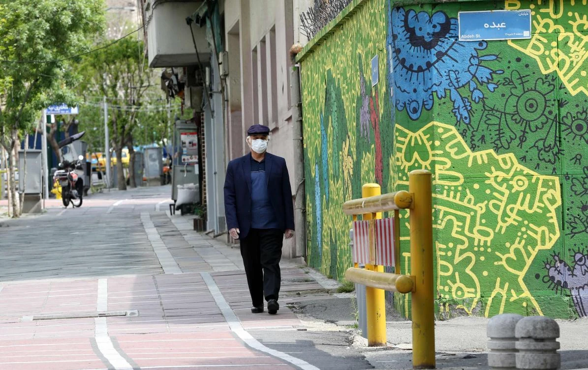 Iran’s total number of cases of people infected with the new coronavirus has reached 77,995. Above, a resident walks the street of Tehran on April 13. (AFP)