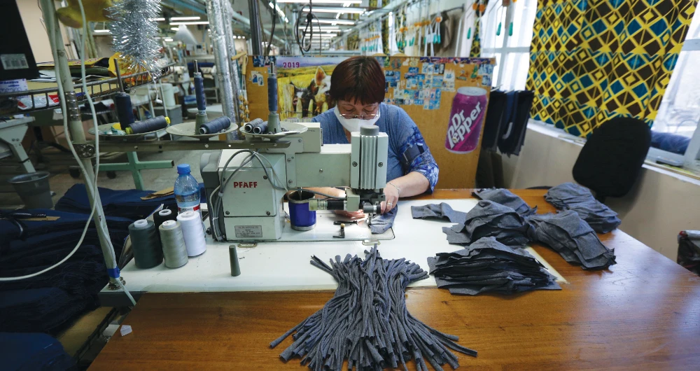 With Asia the dominant supplier of protective gear and masks, some European companies are repurposing machines to help meet rising demands. (AFP)