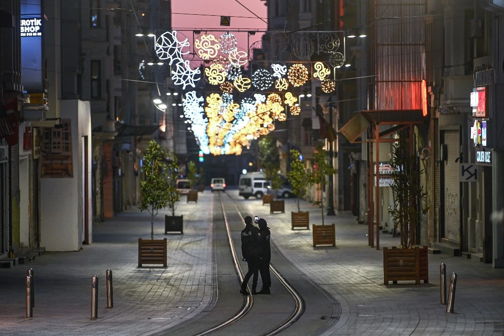 Turkish police officers patrol a deserted Istiklal street at Taksim district in Istanbul on April 12,2020 after a curfew was imposed. (AFP)