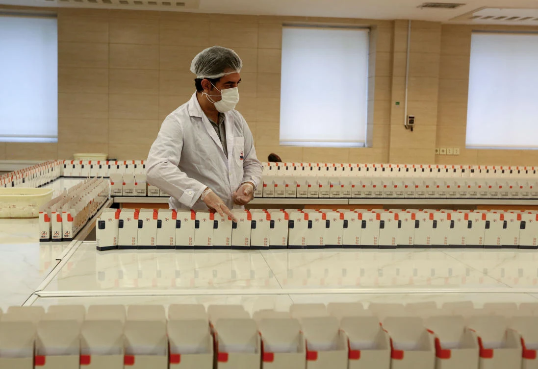 An Iranian member of the medical staff works on the production of COVID-19 test kits at a medical center in Karaj, at the northern Alborz Province, on April 11, 2020. (AFP)
