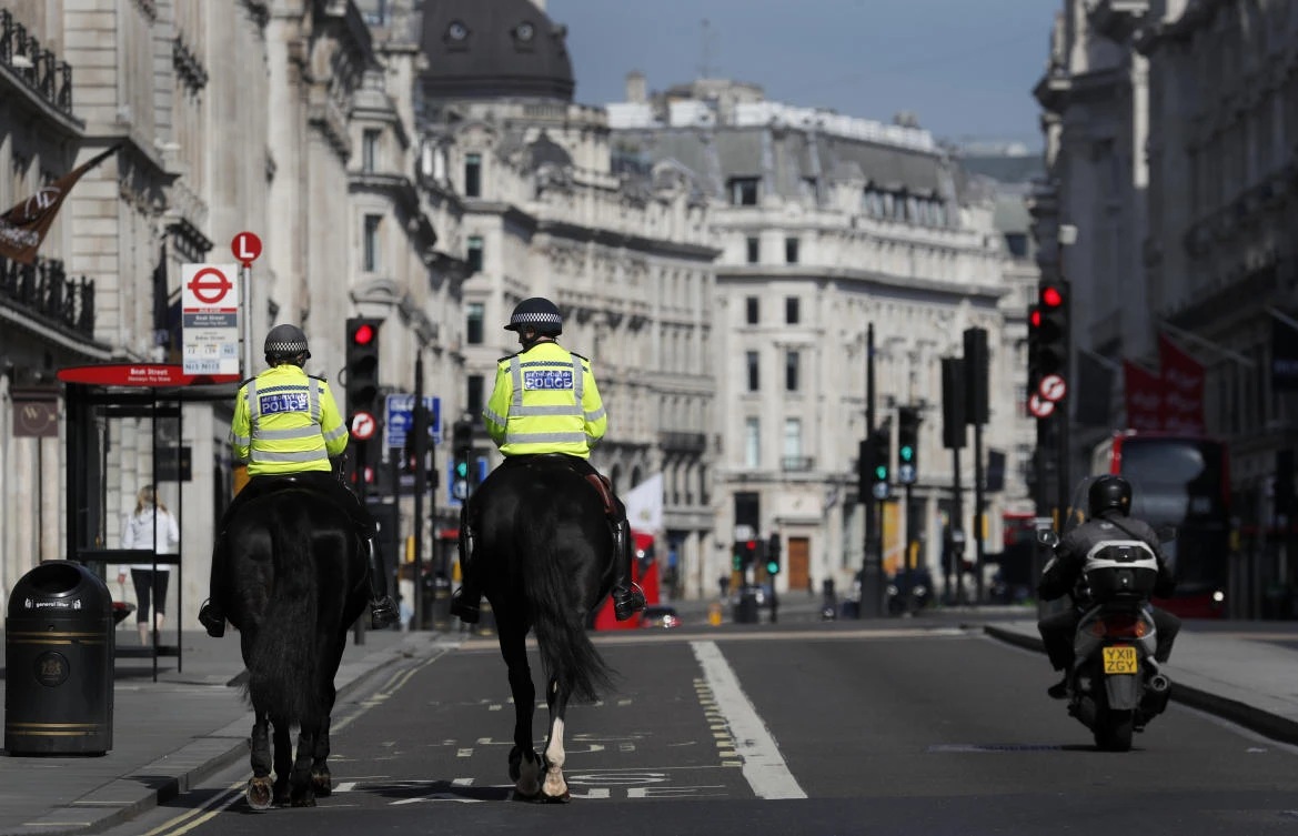 Mounted police officers patrol along a deserted Regent Street in London, as the UK remains in lockdown to help curb the spread of coronavirus, April 15, 2020. (AP Photo)