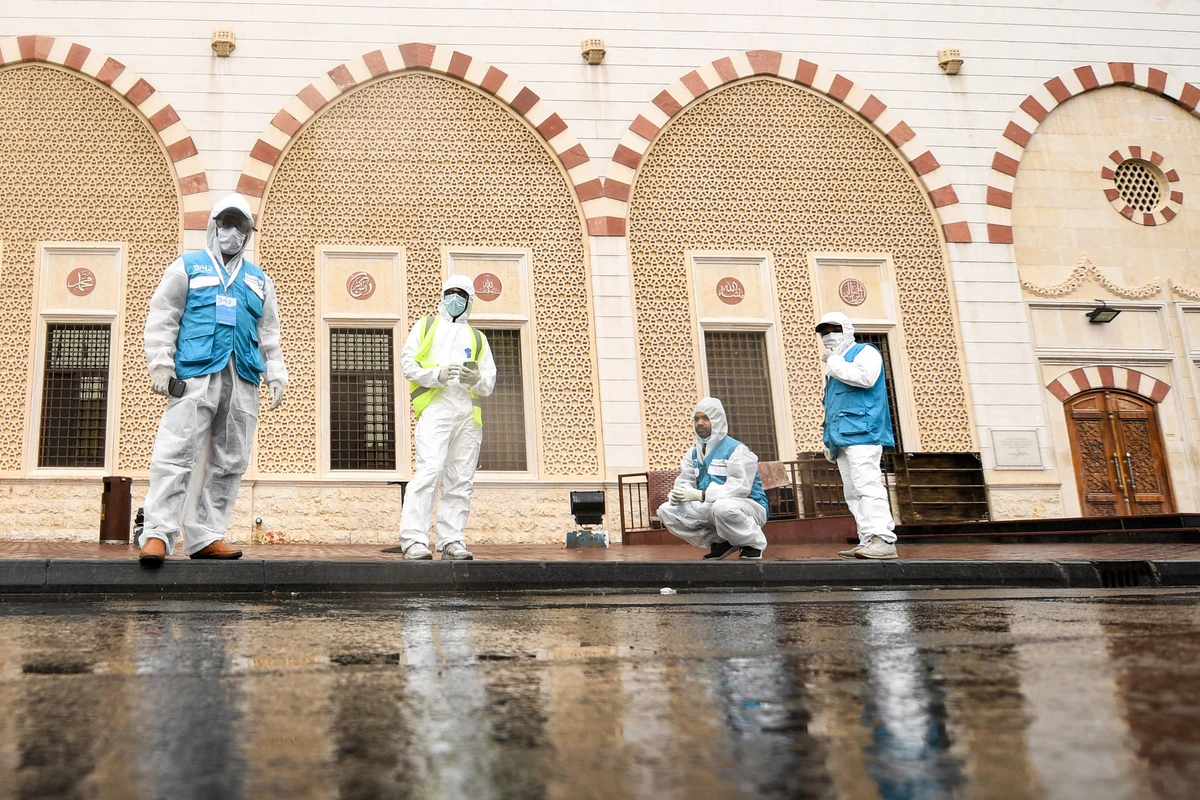 Volunteers of the "Your City Needs You" campaign gather outside a mosque in the Naif locality of the Gulf emirate of Dubai on April 15, 2020. (AFP)