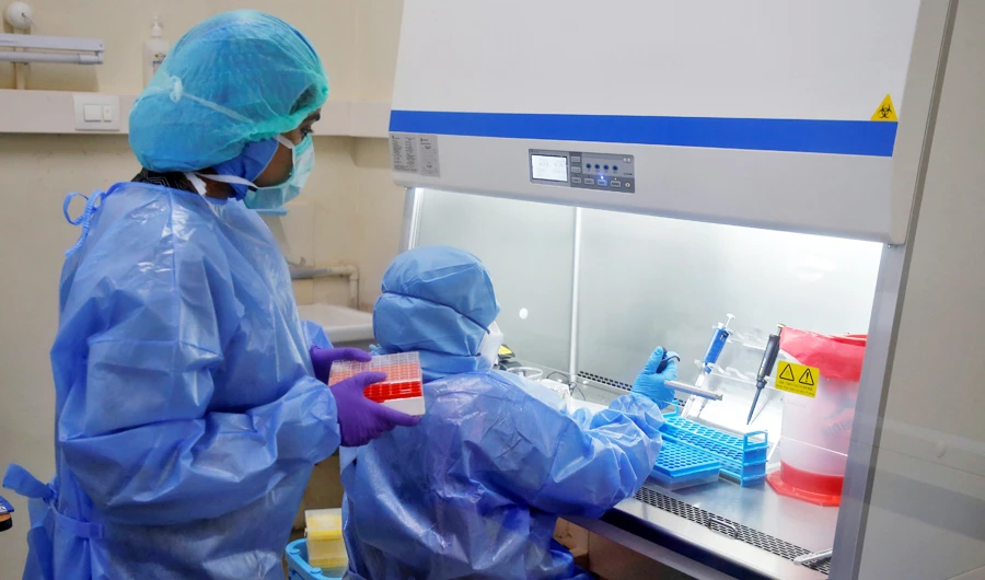 Microbiologists process coronavirus disease (COVID-19) tests in a lab at the Government Medical College in Kochi, India, April 17, 2020. (REUTERS)