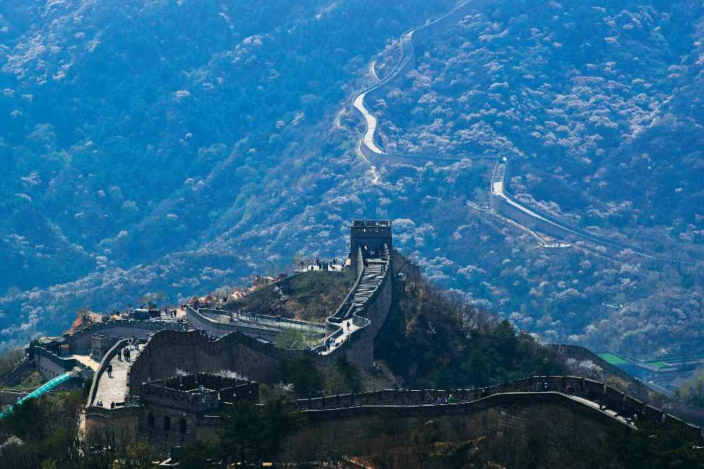 Visitors walk on a stretch of the Great Wall of China after it reopened. (AP)