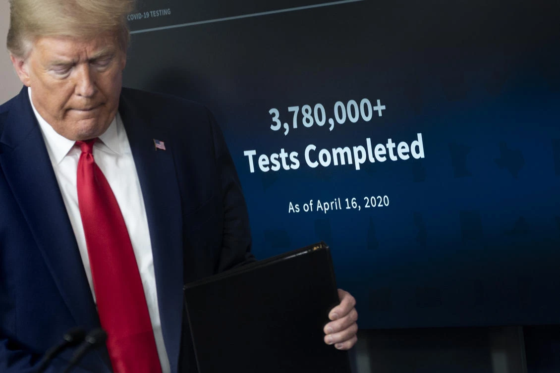A screen shows the number of tests completed as of April 16 as US President Donald Trump arrives to speak during the daily briefing on the novel coronavirus, which causes COVID-19, in the Brady Briefing Room of the White House on April 17, 2020, in Washington, DC. (AFP)