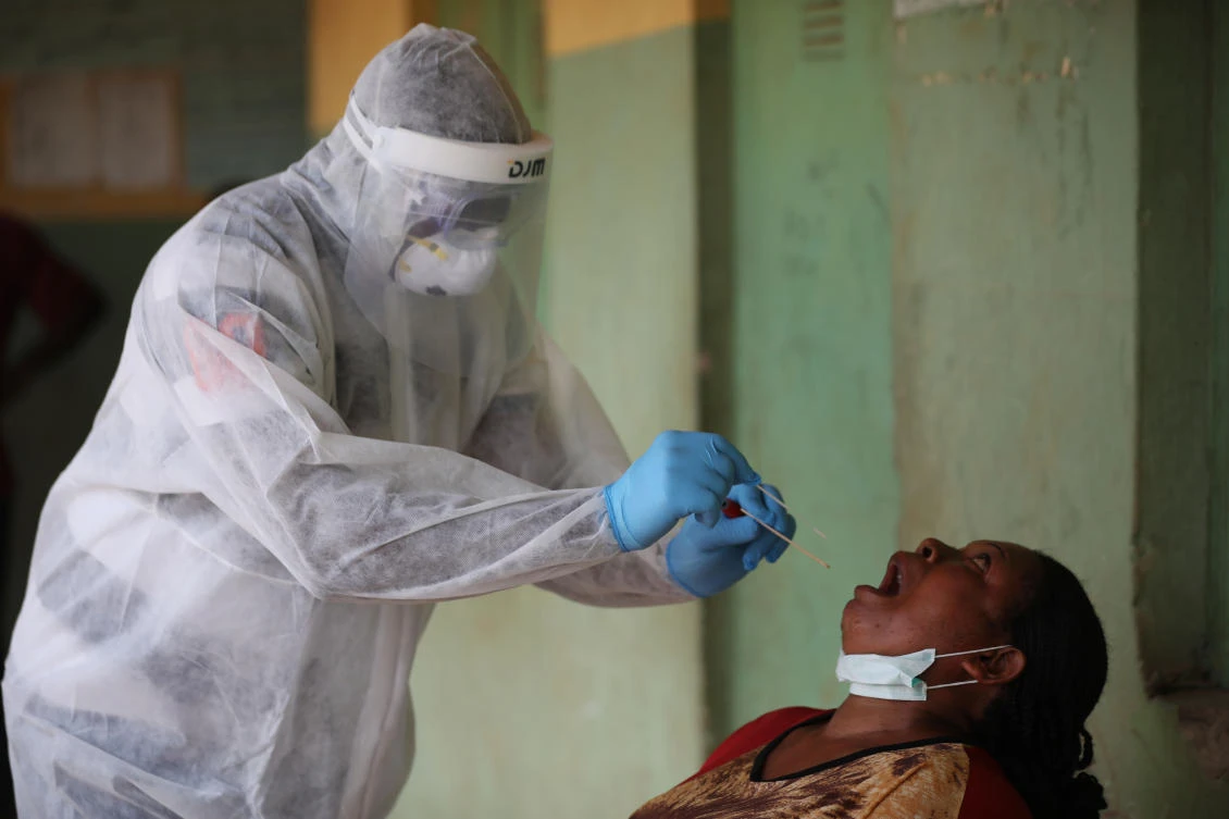 A health worker takes a swab from a woman during a community COVID-19 coronavirus testing campaign in Abuja on April 15, 2020. (AFP)