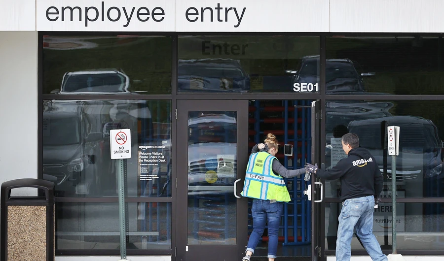 Employees arrrive for work at an Amazon warehouse in Baltimore, Maryland. (AFP)