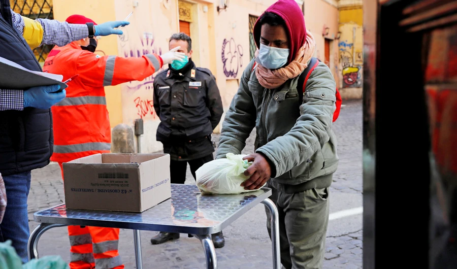 Volunteers work with the charity organisation Circolo San Pietro distributing food to people in need as Italy enters its sixth week of lockdown. (Reuters)