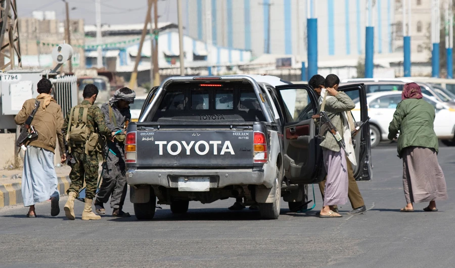 Houthi Shiite Yemenis check a car as they guard a street during clashes near the presidential palace in Sanaa, Yemen, Monday, Jan. 19, 2015. (AP)