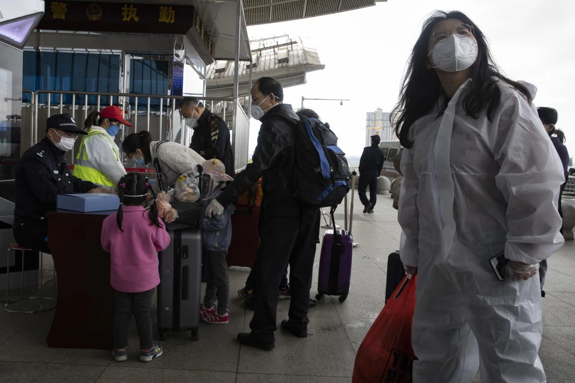 Passengers prepare to enter the train station for a high speed train leaving for Beijing from Wuhan in central China's Hubei province on Sunday, April 19, 2020. (AP)