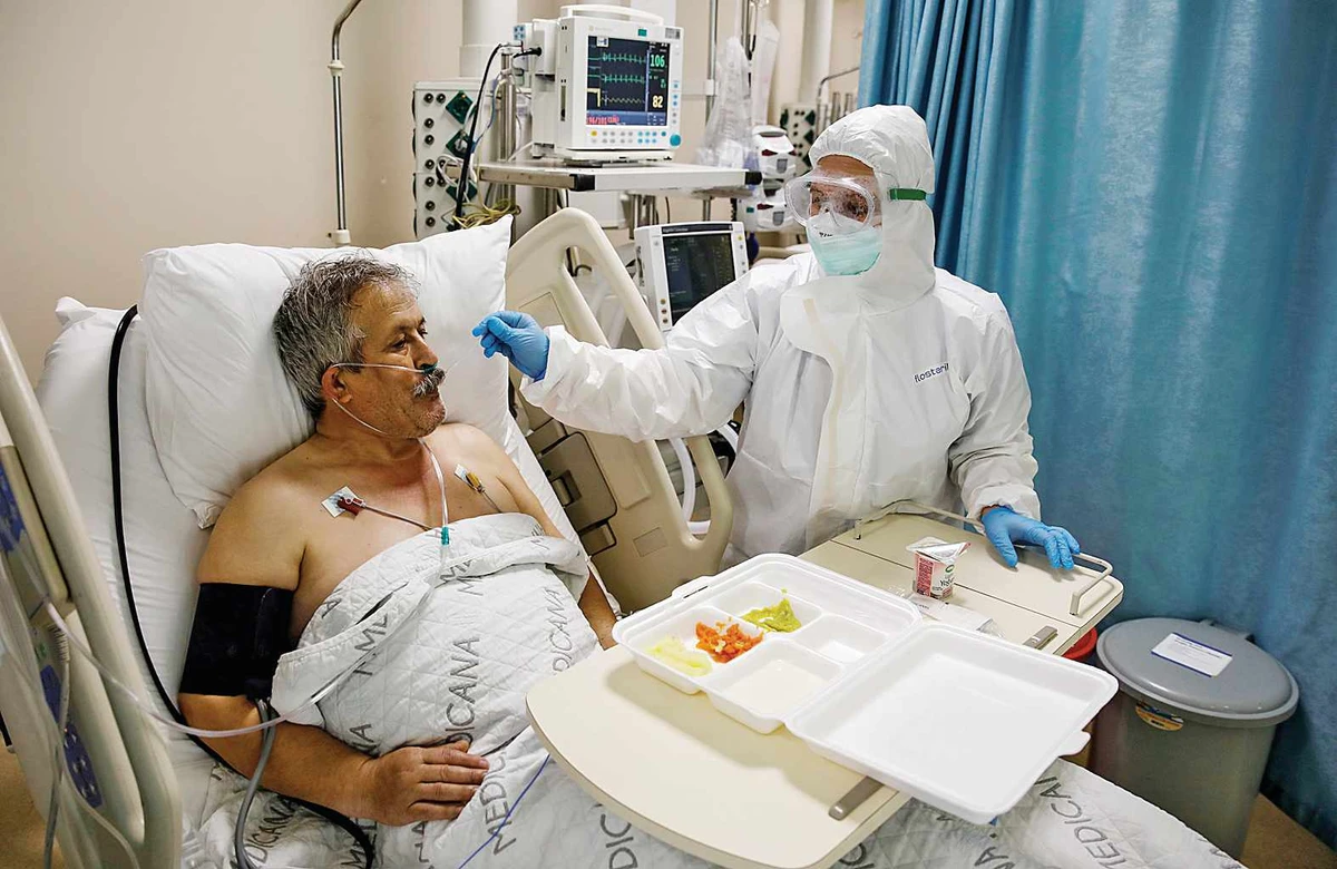 A nurse helps a coronavirus patient at a hospital in Istanbul, Turkey. )Reuters)
