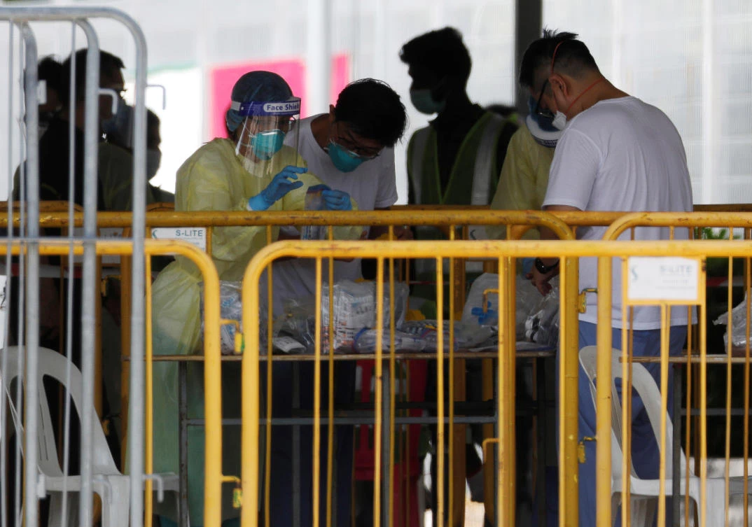 The vast majority of the new cases in Singapore were among migrant workers living in dormitories. Above, medical personnel sort out medical supplies at a dormitory in Singapore on April 20, 2020. (Reuters)