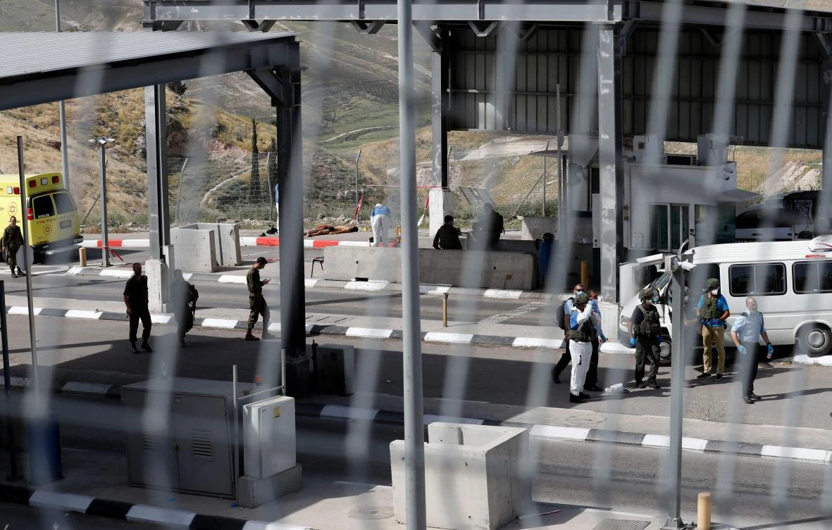 Israeli forces inspect the checkpoint in the occupied West Bank, between the village of Abu Dis and the town of Bethlehem, where the attack happened on April 22, 2020. (AFP)