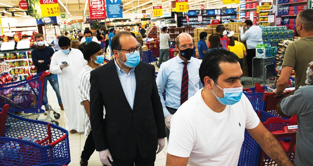 Majid Al Futtaim CEO Alain Bejjani, center left, walks through the Carrefour supermarket, at the Mall of the Emirates in Dubai. (AP)