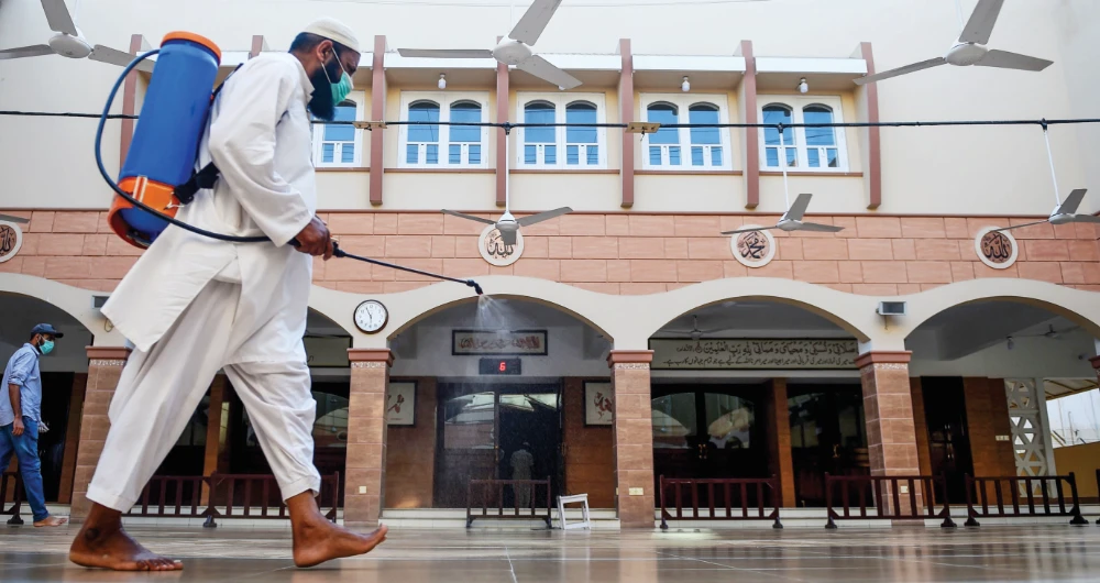 A worker sprays disinfectant at a mosque on Wednesday ahead of the Muslim holy month of Ramadan during a nationwide lockdown in Karachi. (AFP)