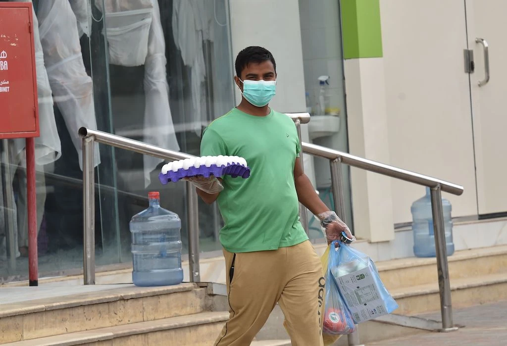 A worker delivers groceries during a nationwide curfew to stem the spread of COVID-19 in the Saudi capital Riyadh on April 13, 2020, ahead of the holy Muslim fasting month of Ramadan. (AFP)