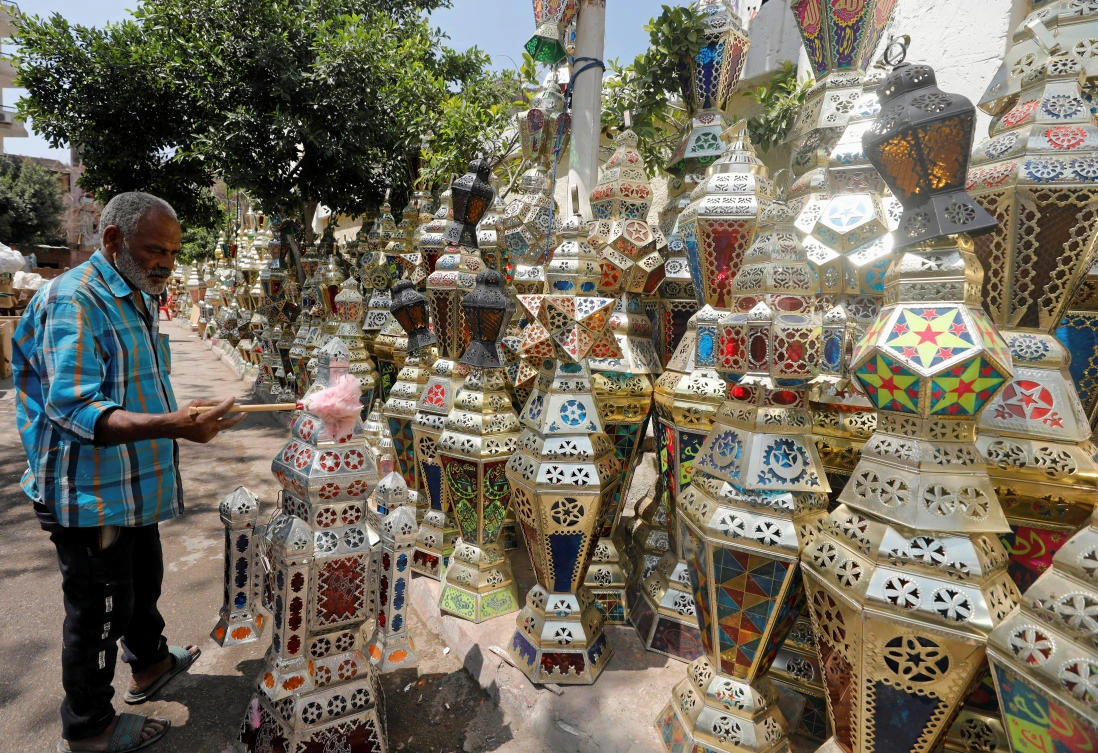 An Egyptian seller cleans a traditional Ramadan lantern called "fanous" at his shop ahead of Ramadan. (File/Reuters)