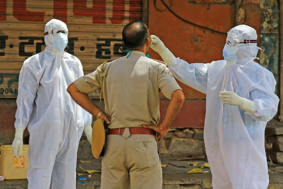 Medics collect a swab sample from a police officer in Jaipur, Rajasthan, India, April 15, 2020. (Getty Images)