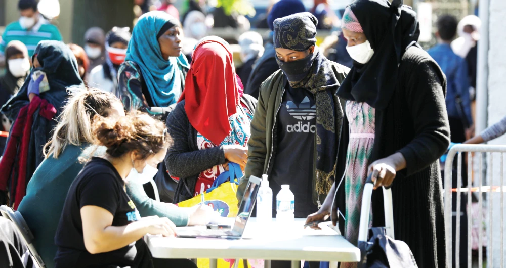 Residents queue for registration during the food distribution by volunteers in Clichy-sous-Bois near Paris during a lockdown imposed to slow the rate of the coronavirus in France. (Reuters)