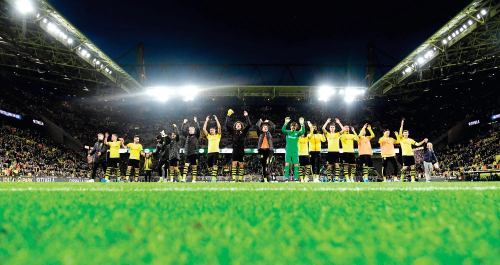 Borussia Dortmund’s players cheer their fans after notching a 3-0 victory over VfL Wolfsburg in this Nov. 2, 2019 file photo. (Files/AFP)