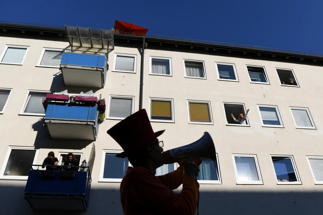 Residents enjoy ‘Bingo on the balcony’ with the artist Max Auerbach in Munich, Germany on Thursday, April 23, 2020. (Reuters)