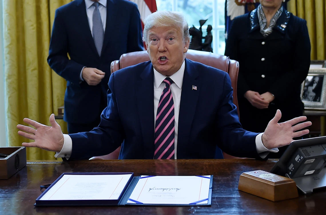 US President Donald Trump speaks after signing the Paycheck Protection Program and Health Care Enhancement Act in the Oval Office of the White House in Washington, DC, on April 24, 2020. (AFP)