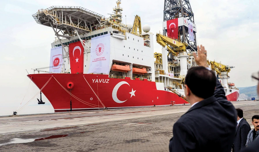 Turkish Energy and Natural Resources Minister Fatih Donmez waves to the drilling ship ‘Yavuz’ which will search for oil and gas off Cyprus, at the port of Dilovasi, outside Istanbul. (AFP)
