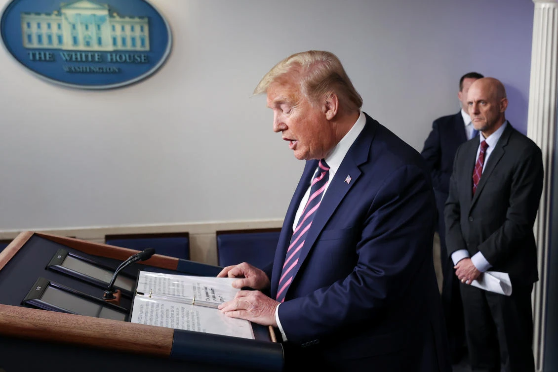 US President Donald Trump leads the daily COVID-19 outbreak task force briefing as Food and Drug Administration (FDA) Commissioner Dr. Stephen Hahn listens at the White House in Washington on April 24, 2020. (REUTERS/Jonathan Ernst)