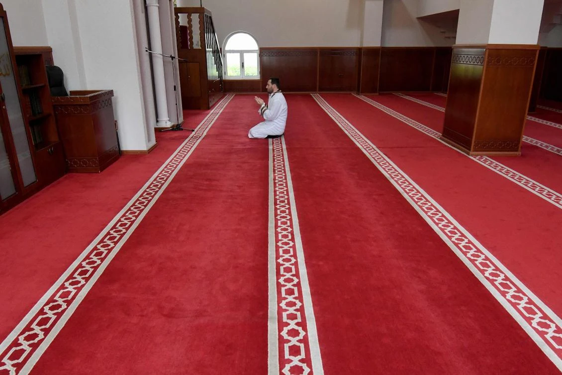 Xhemal Hafizi, Imam of the Tanners’ Mosque, prays alone on the first night of the holy month of Ramadan, in Tirana on April 23, 2020 during a government-imposed nationwide lockdown as a preventive measure against the COVID-19 disease, caused by the novel coronavirus. (AFP/Gent Shkullaku)