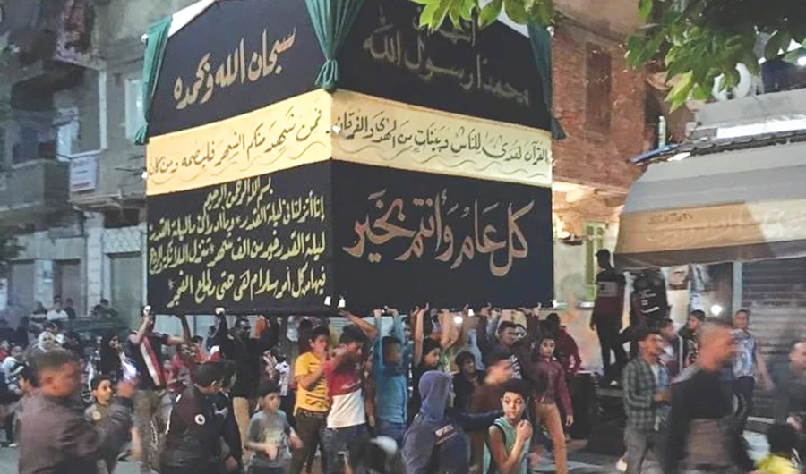 Egyptians carrying a model of Kaaba walk the streets of Alexandria to ‘celebrate the start of Ramadan.’ (AN photo)