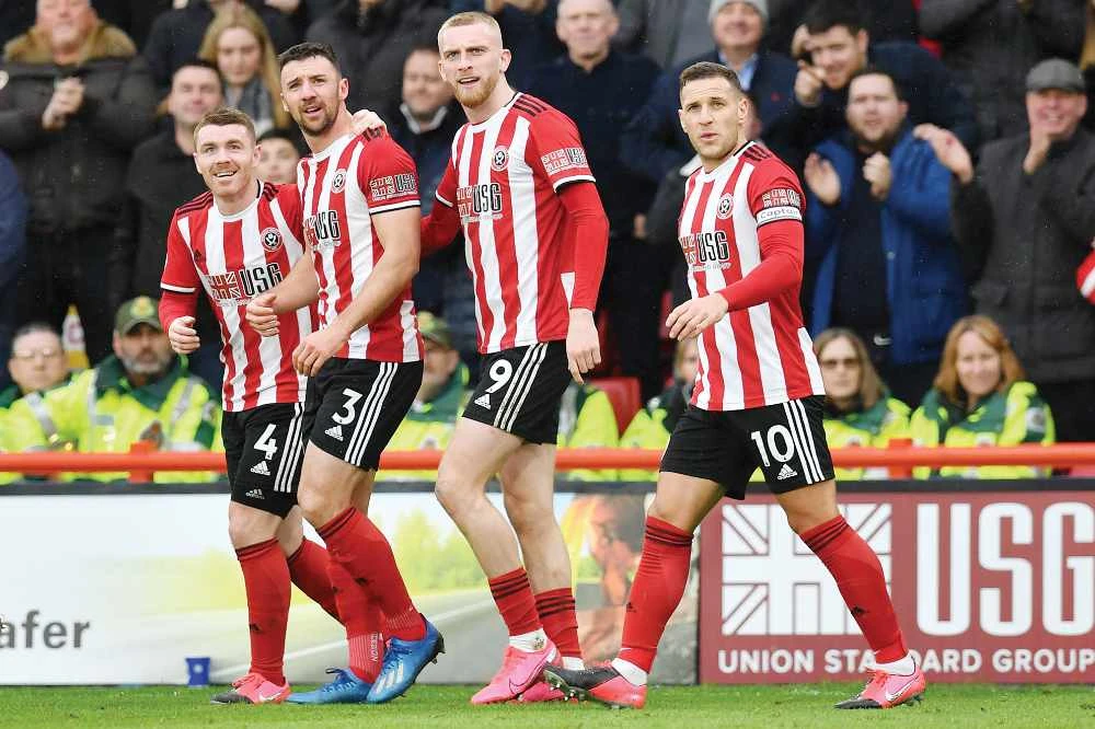 Sheffield United players celebrate after scoring a goal during a Premier League football match against Brighton in northern England recently. (AFP)