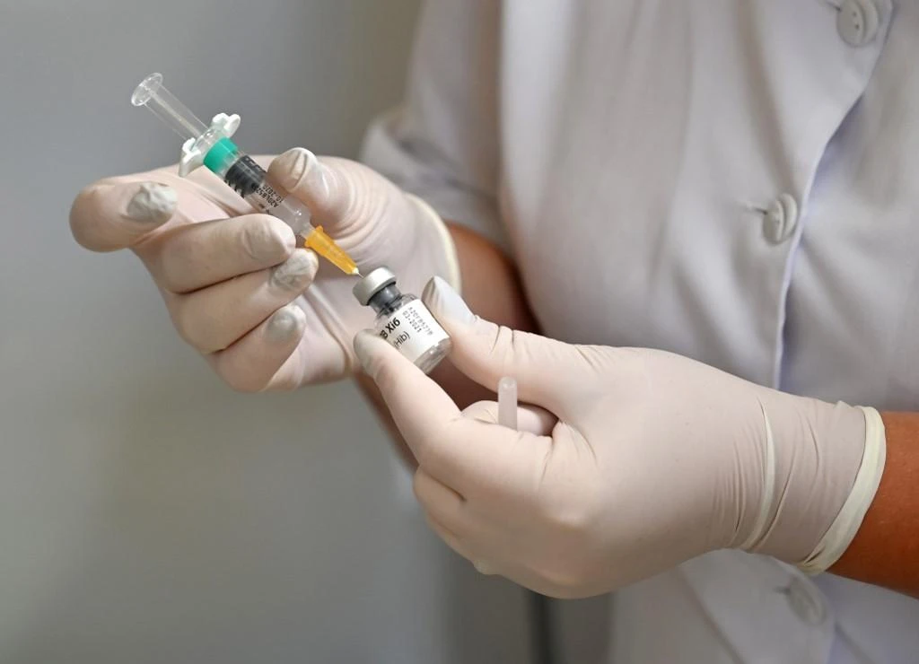 The Council of Cooperative Health Insurance has stated that the Consolidated Health Insurance Policy covers child vaccinations through home medical care for 90 days as a precautionary measure amid the coronavirus outbreak. (File/AFP)