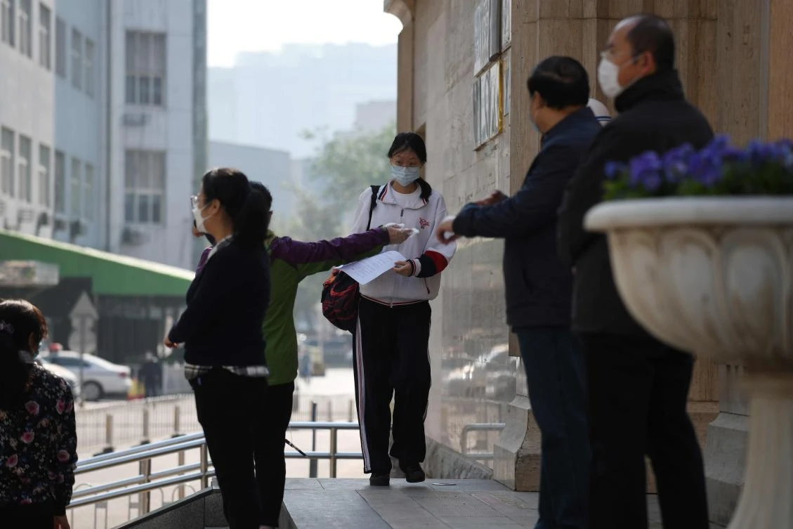 Mainland China now has an accumulated total of 82,830 cases. Above, a student arrives at a high school in Beijing on April 27, 2020. (AFP)