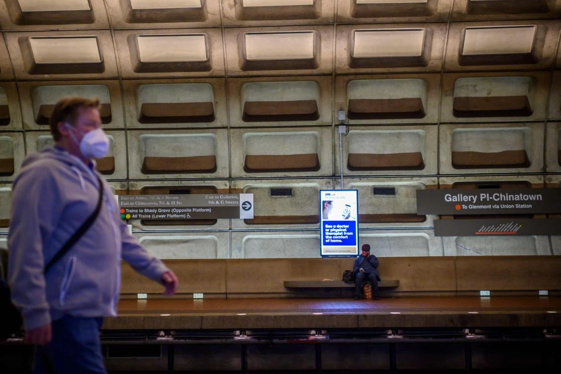 The United States is the country the hardest-hit by the virus with an overall death toll of 54,841 and 964,937 confirmed infections. Above, commuters wait for the train in the metro on April 24, 2020 in Washington, DC. (AFP)