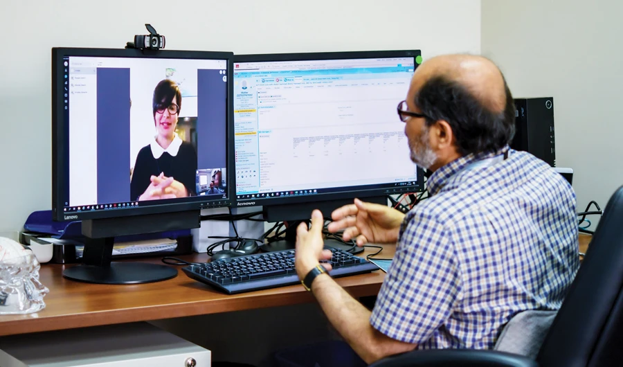 Doctors taking video calls alongside their regular telephone calls from their patients. (Photo/JHAH)