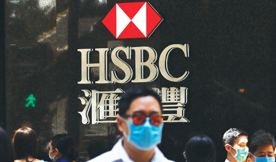 HSBC said first quarter pre-tax profits almost halved as it was battered by the global coronavirus pandemic while it embarked on a major restructuring. (AFP)