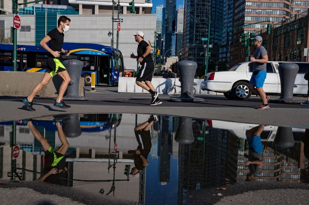 Above, people work out near Hudson River Park on April 28, 2020 in New York City. The US coronavirus death toll has climbed above 58,000. (Getty Images via AFP)
