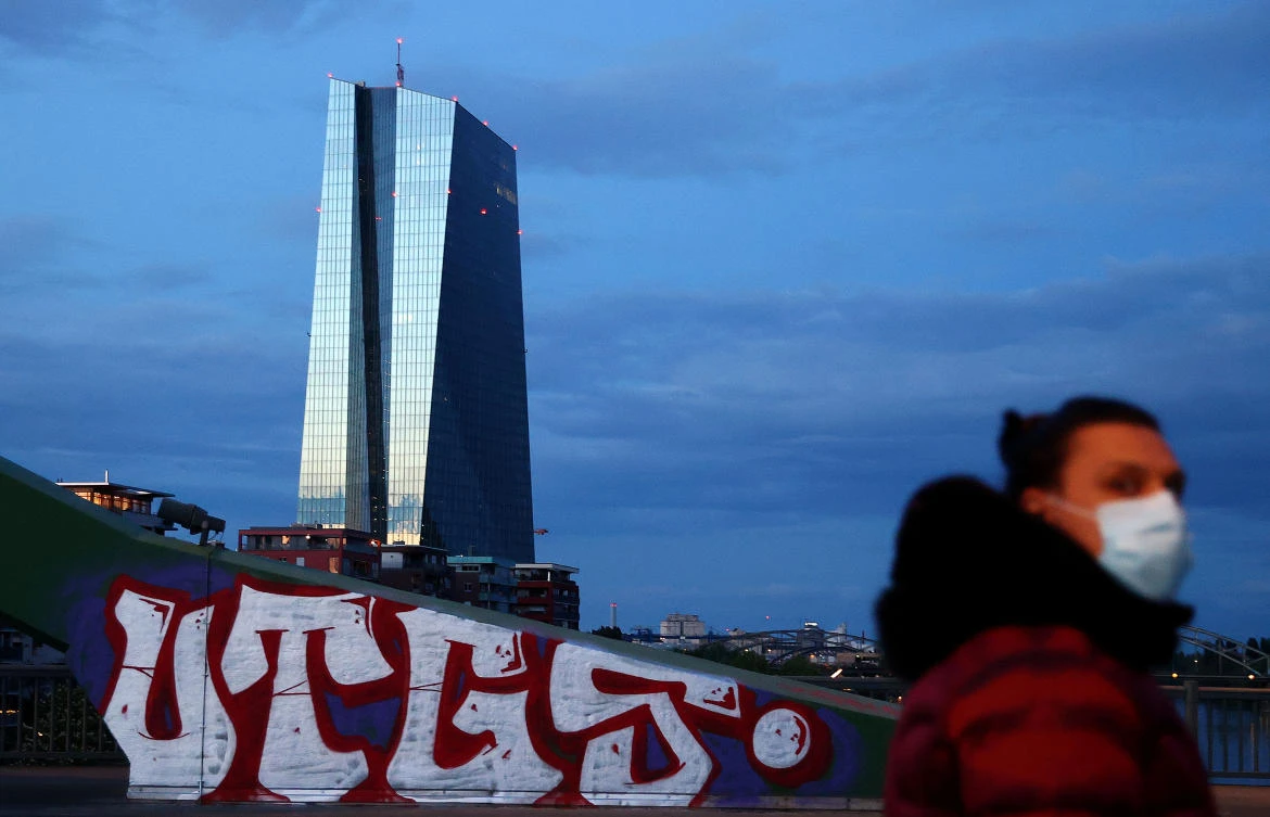 A woman wearing a protective mask walks past the head quarter of the European Central Bank in Frankfurt, Germany on April 29, 2020. (Reuters)