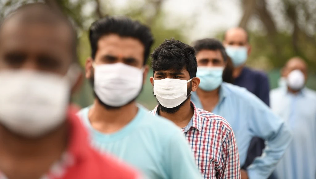 The total number of coronavirus cases in the UAE now stands at 11,929. Above, migrant workers queue to receive their meals during a food distribution activity in Dubai. (AFP)