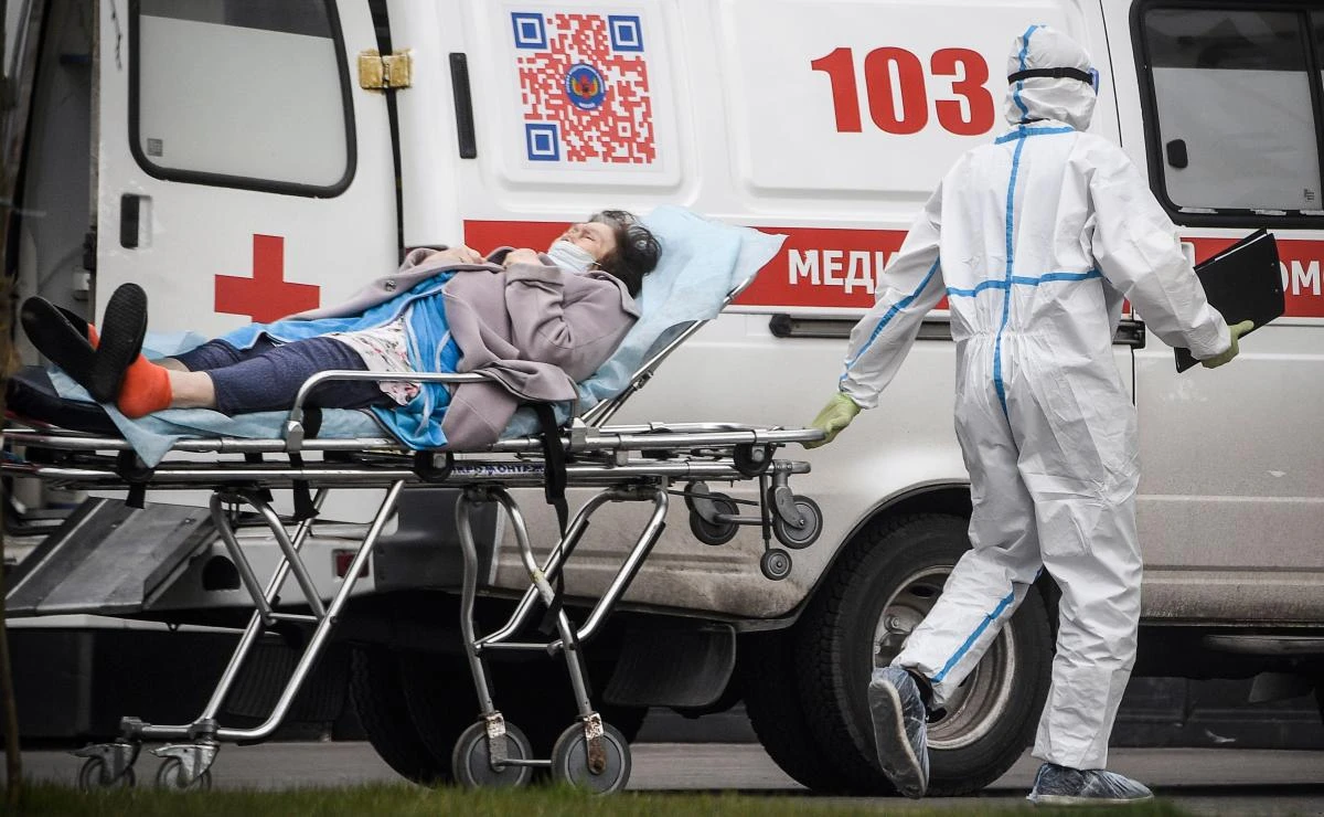 A medic transports a patient to a hospital outside Moscow on April 27, 2020 where patients infected with coronavirus are being treated. (AFP)
