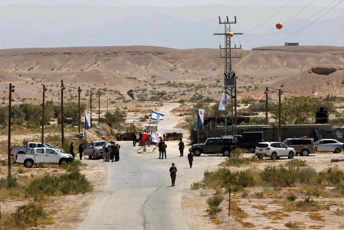 Israeli soldiers gather at the crossing checkpoint on the Israeli-Jordanian border near Moshav Tsofar in the Arava valley, south of the Dead Sea basin, on April 30 2020. (AFP/Menahem Kahana)