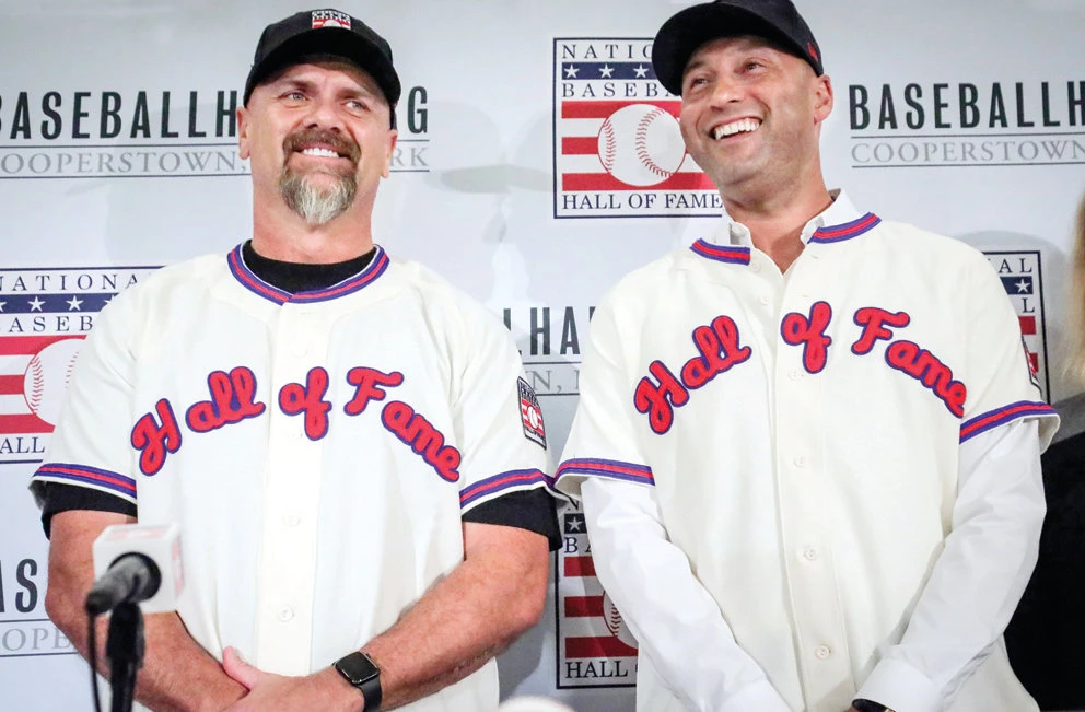 Former New York Yankees shortstop Derek Jeter, right, and former Colorado Rockies outfielder Larry Walker after receiving their Baseball Hall of Fame jerseys. (AP File Photo)