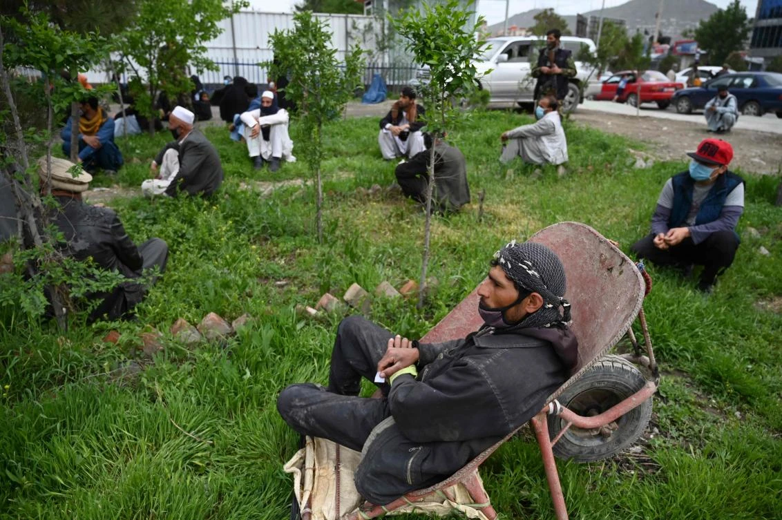 Rising food prices in Afghanistan likely will worsen the coronavirus crisis, a US watchdog said. Above, people wait to receive free bread from the municipality outside a bakery in Kabul on April 29, 2020. (AFP)
