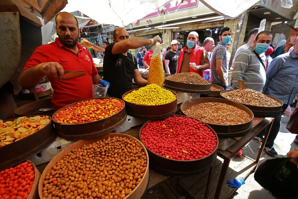 Jordan has allowed small shops and businesses to open but with great emphasis on public health and safety. Above, residents at a market in Amman on April 23, 2020. (AFP)